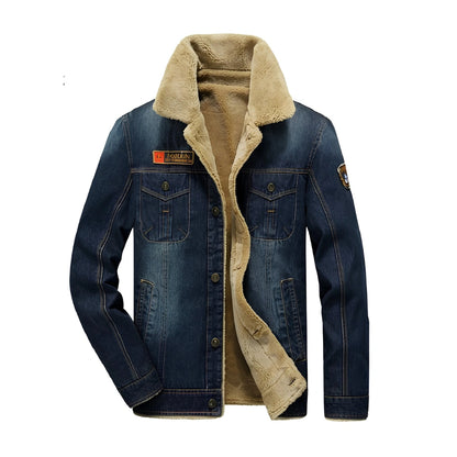A men's dark blue denim jacket with a thick beige sherpa fleece lining, featuring a high collar, button front, and chest pockets.