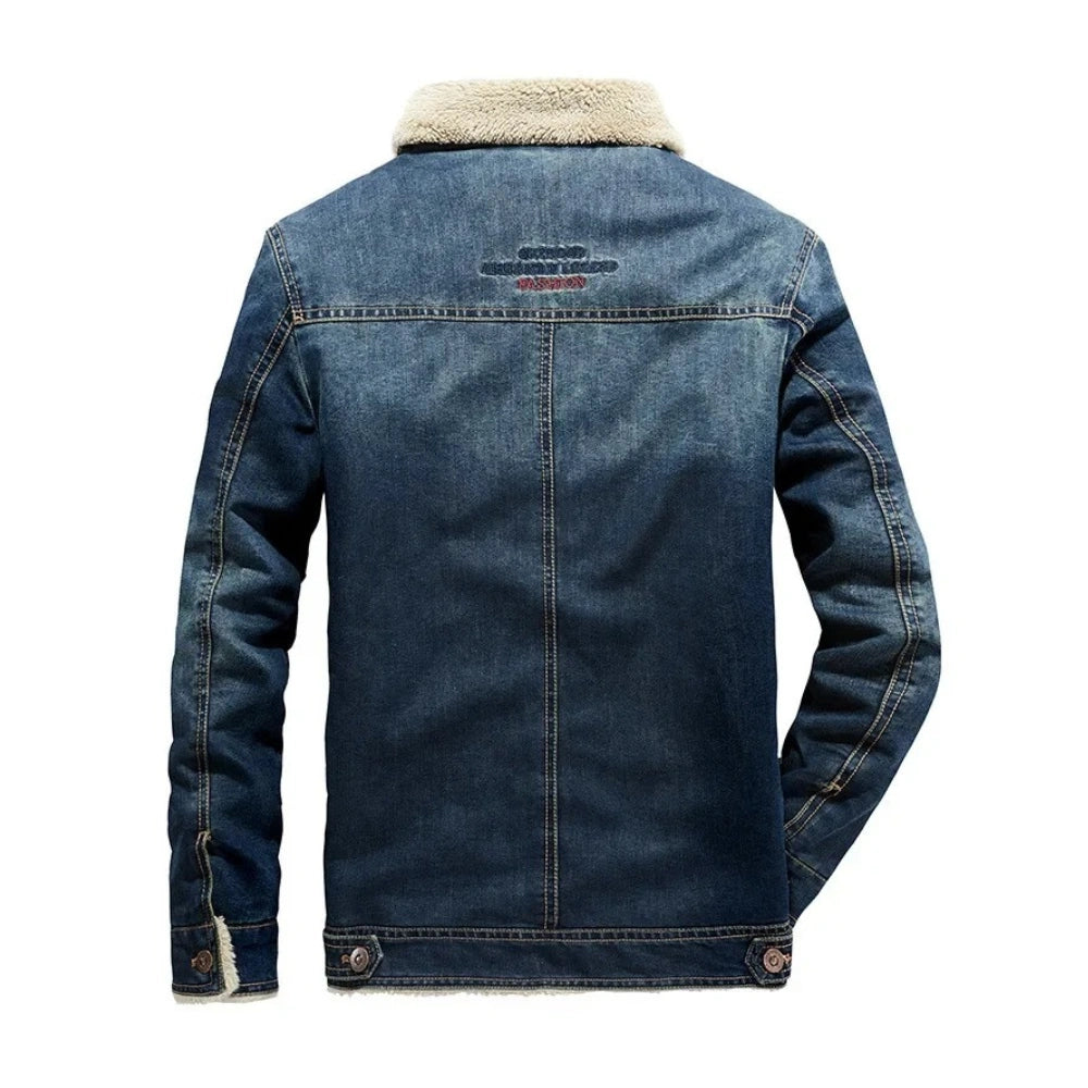 A men's dark blue denim jacket with a beige sherpa fleece collar, shown from the back on a white background.