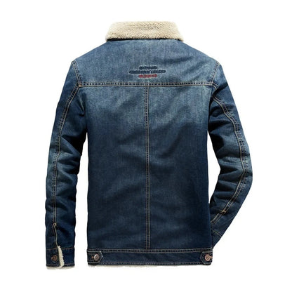 A men's dark blue denim jacket with a beige sherpa fleece collar, shown from the back on a white background.