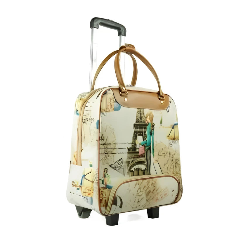 A rolling travel bag with an Eiffel Tower and Parisian script collage print, featuring tan leather handles and trim, a telescoping silver handle, and wheels.