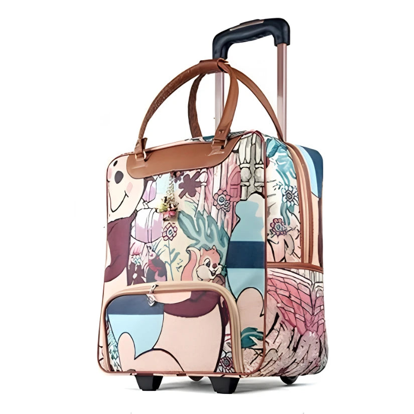 A compact rolling suitcase with a colorful cartoon and floral print, featuring brown leather-like handles and trim, a telescoping handle, and two wheels, shown on a plain white background.
